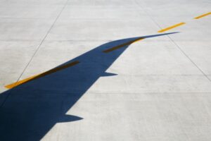 Shadow of aircraft wing on tarmac