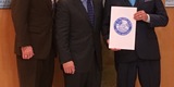 Orlando Commissioner Robert Stuart, left; UWWM Mediator/Arbitrator Lawrence Kolin, center; and Mayor Buddy Dyer pose for a picture after the City Council meeting.