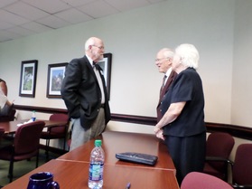 Mediator Howard Marsee, left, chats with Alex and Anna Jernigan, parents of mediator Michelle Jernigan.